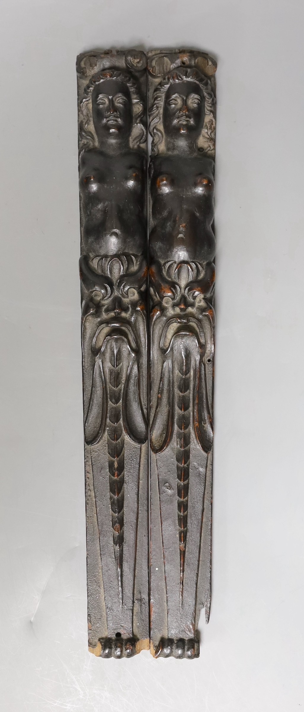 A pair of 18th century French carved walnut appliques, 39.5 cms long